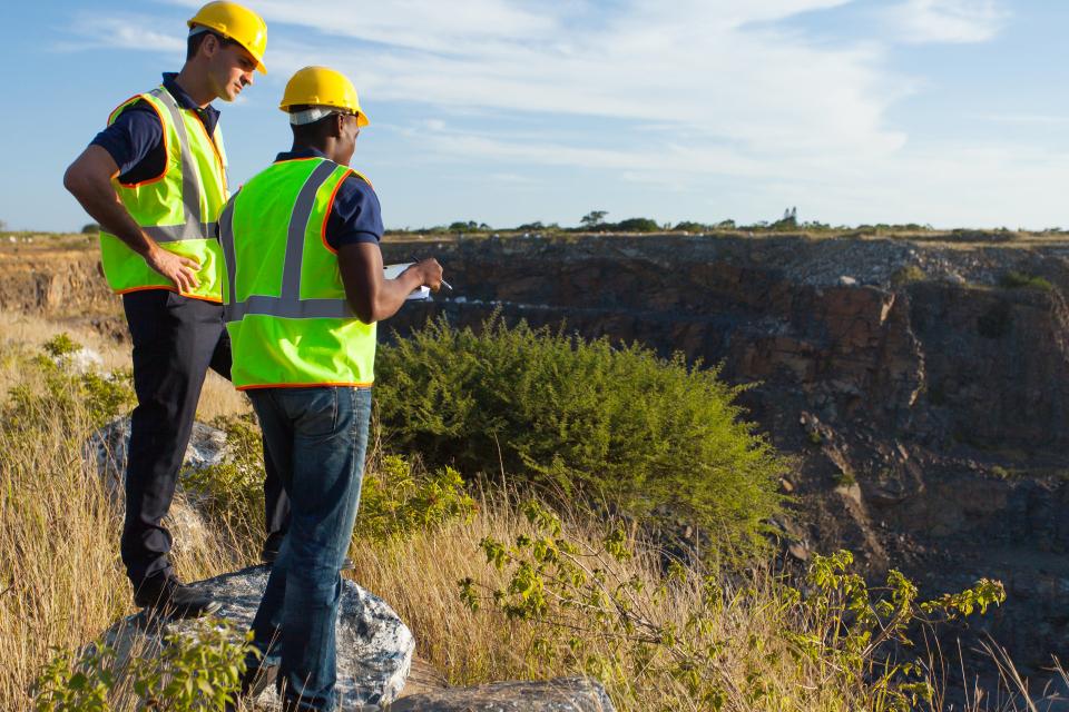 two men surveying land